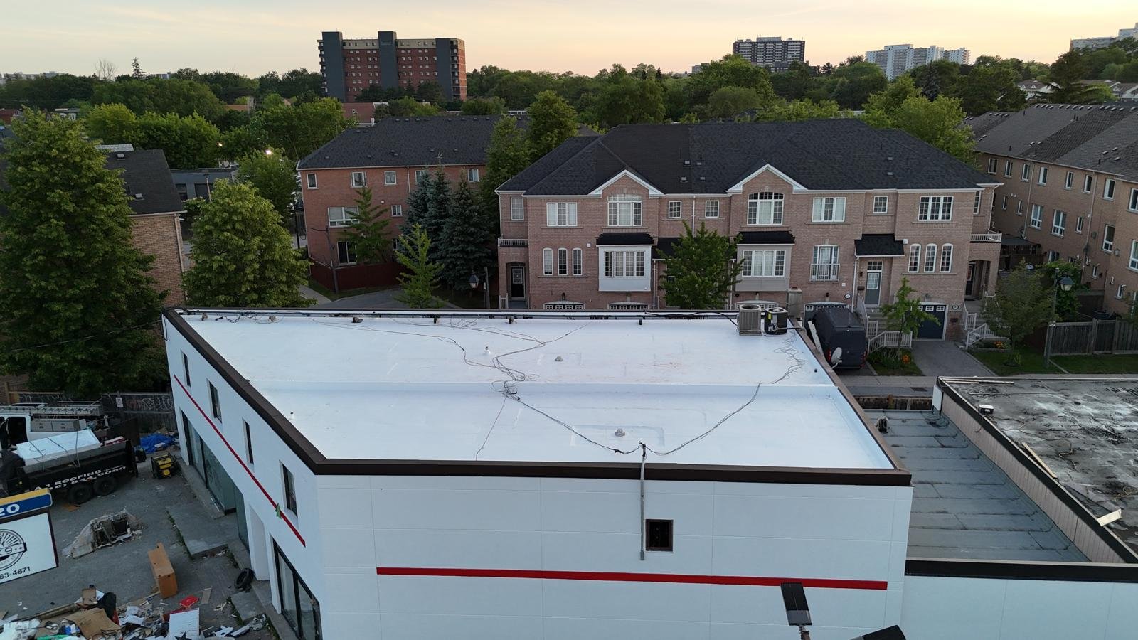 Aerial view of a completed white commercial flat roof